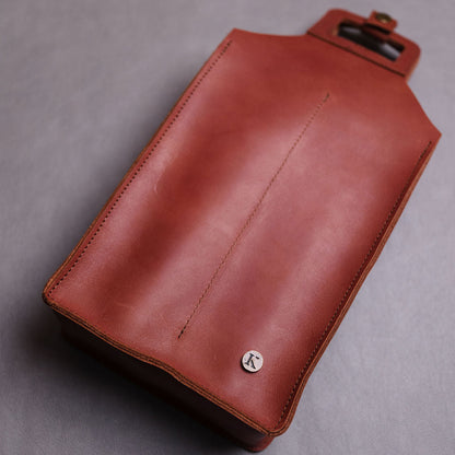 Brown leather wine bag on a grey background